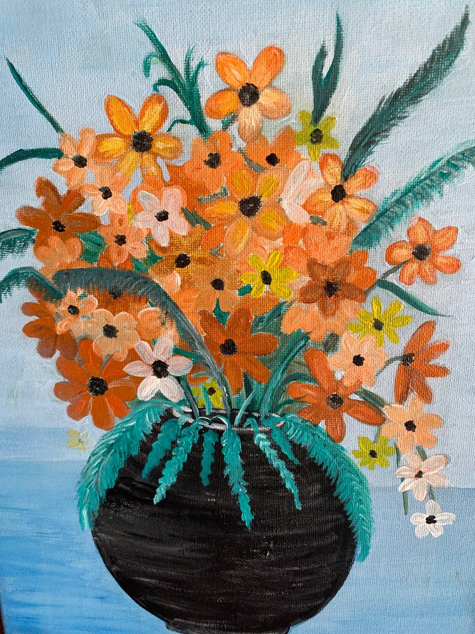 Orange floral arrangement in dark vase
